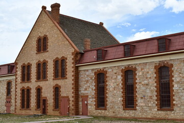 Vintage prison in Wyoming USA. Large multi story stone building. Compound view.