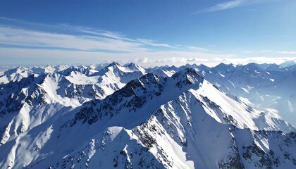 Snowy mountain peaks against a clear blue sky.