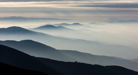 Obraz premium Serene Mountain Range Landscape with Morning Mist and Atmospheric Perspective