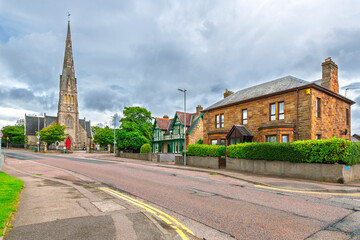 The tall spire of the 1861 Invergordon Church of Scotland above the seaside town of Invergordon, Scotland, in the Scottish Highlands.