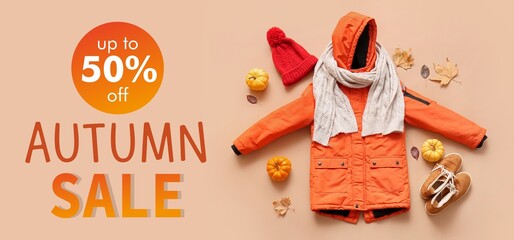 Stylish kid's clothes with pumpkins and autumn leaves on brown background. Autumn Sale