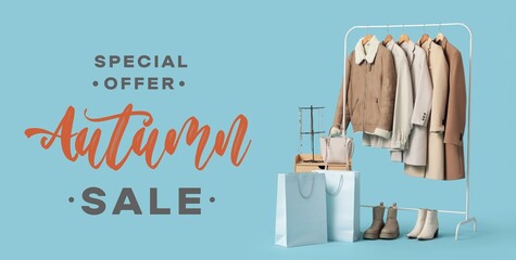 Hanger with clothes and shopping bags on blue background. Autumn Sale