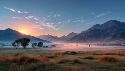 Sunrise over misty valley mountains