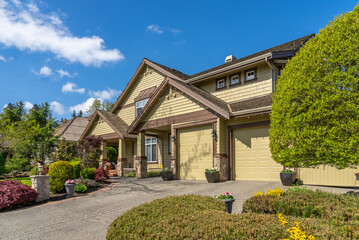 Two story stucco luxury house with nice spring blossom landscape in Vancouver, Canada, North...
