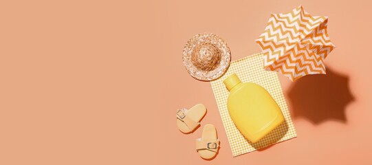 Composition with sunscreen cream and beach accessories on orange background with space for text