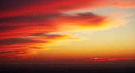 Fototapeta premium Dramatic Colorful Sunset Sky with Fiery Clouds and Deep Hues of Red Orange and Yellow Creating a Beautiful Natural Vista
