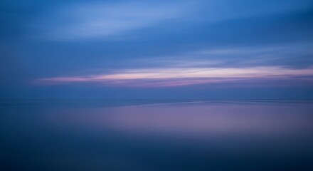 Obraz premium Tranquil Seascape at Dusk with Soft Blue and Purple Hues Reflecting on the Water Surface a Moment of Peace