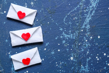 Envelopes with hearts on blue grunge background. Valentine's Day celebration