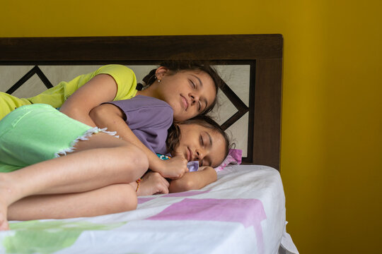 Picture of siblings sleeping on bed. Parenting, love, sisterhood, rakshabandhan, Indian, bed, nap, tried, playing, sport, engage, support, care, hug, hair, system, family, teenagers, childhood, school