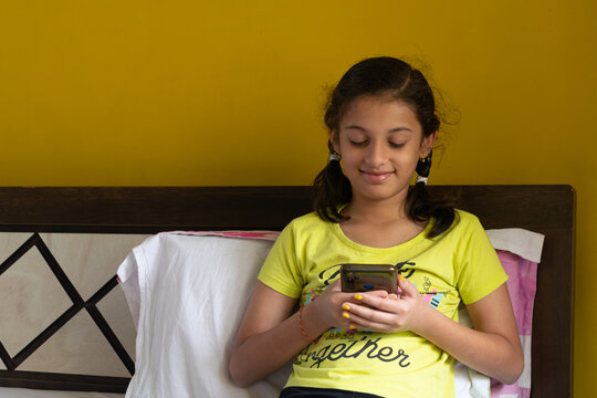 Girl watching mobile phone. Technology, addiction, knowledge, screentime, parents, children, young autism digital wellbeing future indian content online fraud gaming reels video chatting mental health