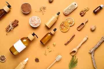 Bottles of essential oil and different ingredients on brown background