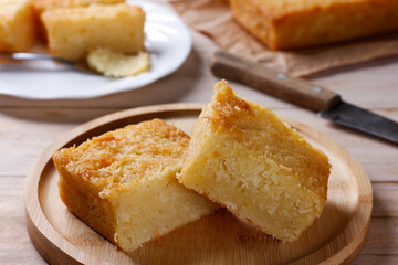 Traditional homemade cassava cake whit coconut on a rustic wooden table