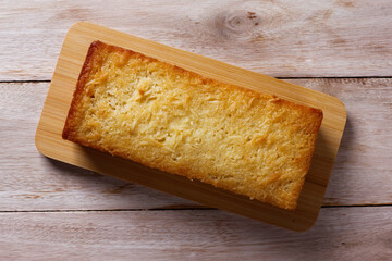 Traditional homemade cassava cake whit coconut on a rustic wooden table