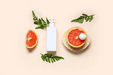 Composition with grapefruit, fern twigs, jar and bottle of cosmetic product on light background