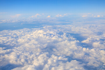 Clouds in the sky under the wing of an airplane