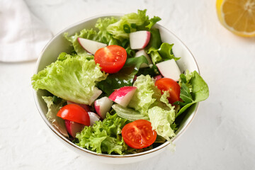 Bowl of healthy salad on light table