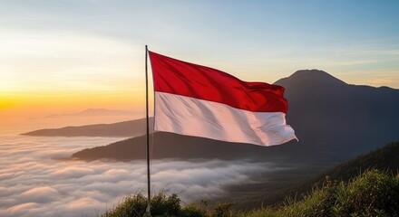 Indonesian flag at sunrise over mountains