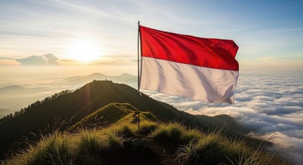 Flag waving over misty mountains at sunrise