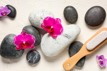 Spa stones, pumice and orchid flowers on white background