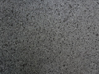濃灰色のざらざらした石のテクスチャ