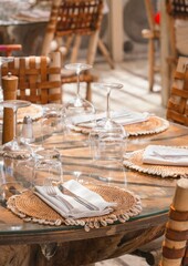 Close up boho style table setting beach club restaurant with natural materials
