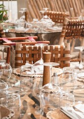 Close up boho style table setting beach club restaurant with natural materials
