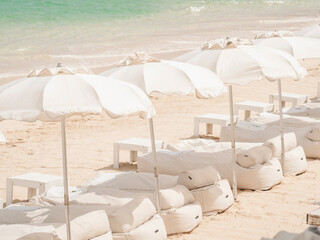 Close up loungers and umbrellas at beach club Grand Case Saint Martin
