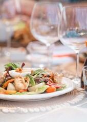 luxury caesar salad on seashell placemat at bright tropical restaurant in caribbean