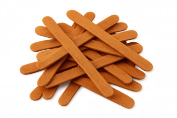 Chaotic orange wooden sticks piling haphazardly, creating geometric shapes with sharp angles against clear backdrop