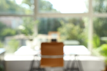 Blurred view of workplace with plant near window in office