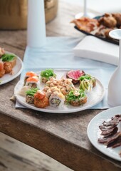 luxury sushi platter photo in caribbean beach club restaurant with blurred dishes in background and champagne glass