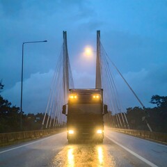 Fototapeta premium Truck on a cable-stayed bridge at night