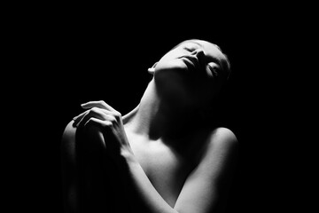 Silhouette of young woman on dark background, closeup