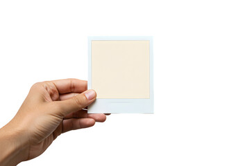 Hand holding an instant photo frame with copy space against a isolated on white transparent background evoking nostalgia and memory, perfect for mockups, PNG Format.