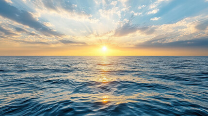 Obraz premium Sunset over calm ocean water with vibrant colors and dramatic clouds creating serene atmosphere