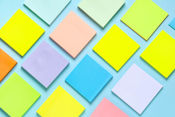 Many colorful sticky notes on blue background