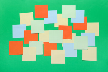 Blank sticky notes on green background