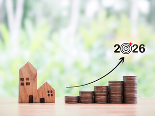 Miniature house and stack of coins with arrow rising up. The concept about price of house is...