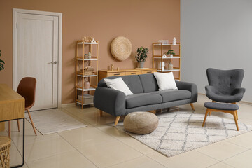 Interior of stylish living room with grey sofa, armchair and white door