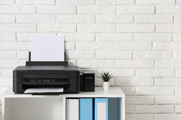 Shelving unit with modern printer and folders in light home office