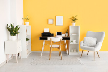 Workplace with modern printer and laptop in stylish home office