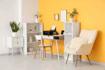 Workplace with modern printer and laptop in stylish home office