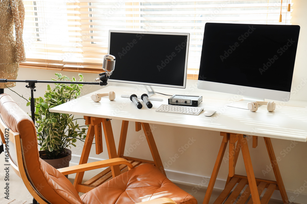 Aufkleber workplace with computer monitors and microphone in recording studio