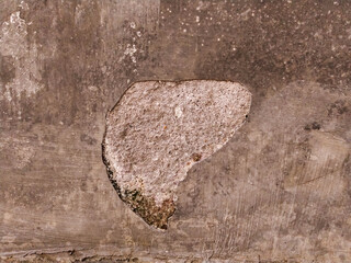 Damaged walls appear as if the cement is loose or the paint is peeling.