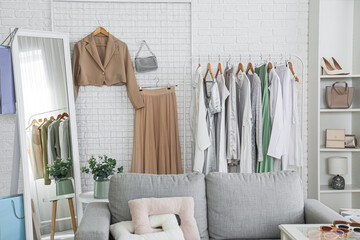Interior of stylist's studio with clothes rack, pin board and mirror