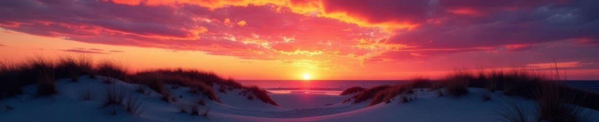 Fototapeta premium Fiery November sunset paints sky above Hampton's Beach dunes , yellow, shoreline, color