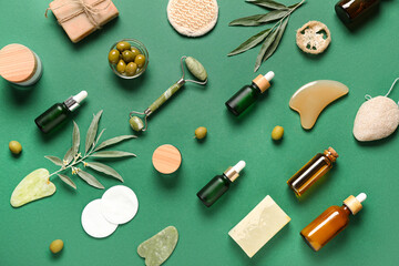 Composition with spa accessories, natural cosmetic products and green olives on color background