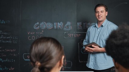 Caucasian teacher answering student question about coding program. Caucasian girl raised hand to ask, vote, volunteer, answer while laptop display system screen at STEM technology class. Edification - Powered by Adobe