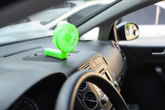 Fototapeta Mini electric fan on car dashboard