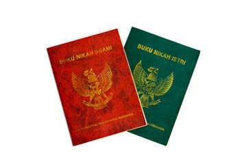 A pair of buku nikah (marriage certificates) for a suami (husband) and istri (wife) isolated on a...